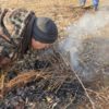 Flint and Tinder | Fire Making Basics For Everyday Survivalists Like You man-starting-fire-with-tinder-750x420-7b3bcbfb0d18f56929cc5f060c67535433e48ae7